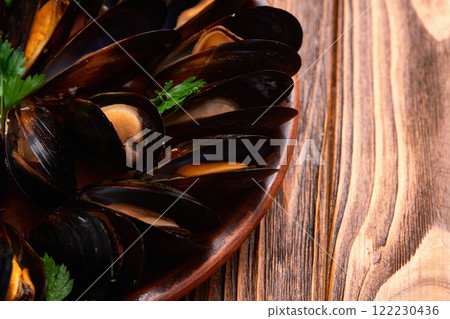 Mussels with parsley on a plate photography 122230436