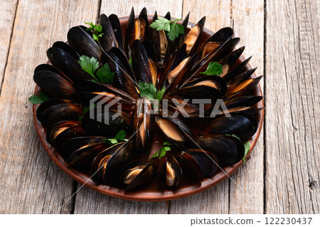 Mussels with parsley on a plate photography Mussels with parsley on a plate photography 122230437