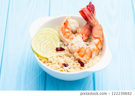 Tom yum soup with shrimps instant noodles and lime photography . Asian food . Top view 122230682