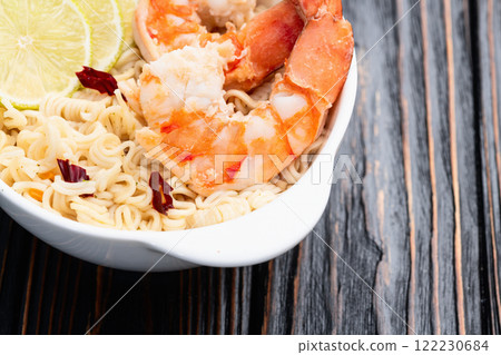 Tom yum soup with shrimps instant noodles and lime photography . Asian food . Top view Tom yum soup with shrimps instant noodles and lime photography . Asian food . Top view 122230684