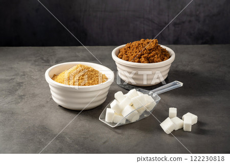 Different type of sugar. Light brown, dark brown and white sugar cubes in bowls. 122230818