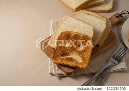 Gluten allergy, one slice of tasted bread with sad face. Copy space Gluten allergy, one slice of tasted bread with sad face. Copy space 122230892