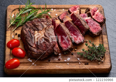 Ribeye grilled beef steak sliced . Rare doneness photography . Top view Ribeye grilled beef steak sliced . Rare doneness photography . Top view 122230966