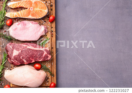 Mix of raw meat and fish . Salmon , beef , pork , chicken staek . Top view 122231027