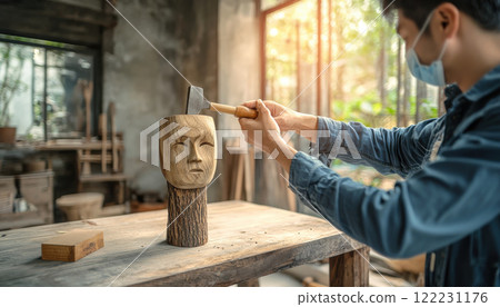 Craftsman carving intricate patterns into wooden mask in workshop Craftsman carving intricate patterns into wooden mask in workshop 122231176