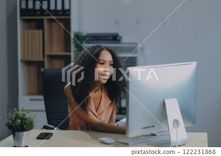 Female business person using digital tablet and laptop or remote working at home office, looking at digital tablet watching webinar, learning training, studying online seminar or video calling. Female business person using digital tablet and laptop or remote working at home office, looking at digital tablet watching webinar, learning training, studying online seminar or video calling. 122231868