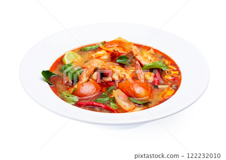 Closeup plate of traditional thai soup - tom yum kung with shrimps and tomatoes isolated at white background. Closeup plate of traditional thai soup - tom yum kung with shrimps and tomatoes isolated at white background. 122232010