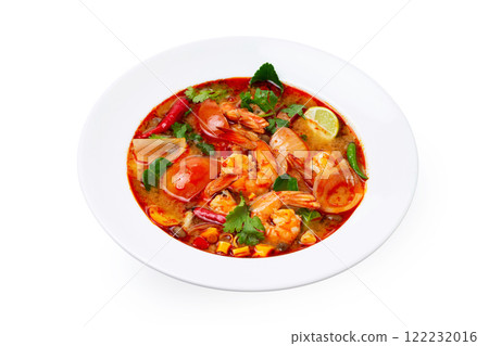 Closeup plate of traditional thai soup - tom yum kung with shrimps and tomatoes isolated at white background. 122232016