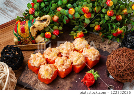 Set of hot california sushi rolls with lava maki at decorated table background. 122232026