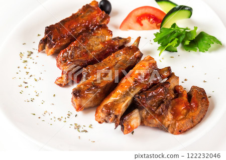 Plate of fried golden chicken wings and legs isolated at white background. 122232046