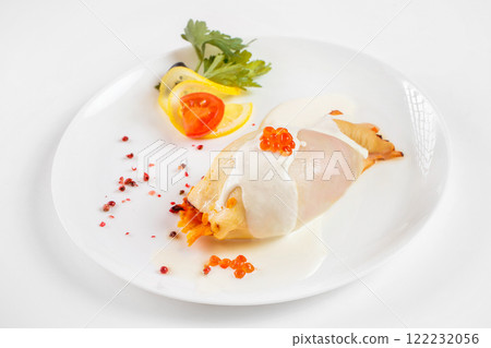 Steamed calamari filled with vegetables decorated with red caviar isolated at white background. 122232056