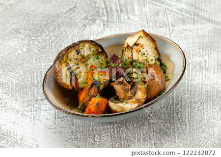 Closeup plate of grilled vegetables - potato, mushrooms, pumpkin and squash at concrete table background. 122232072