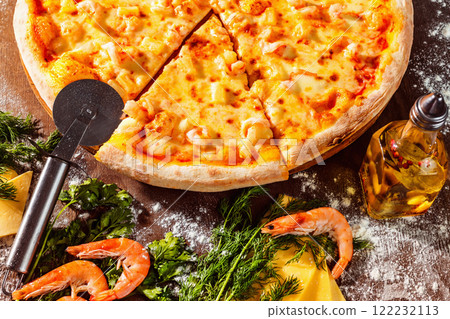 Tasty italian pizza with fresh golden cheese, shrimps and olive oil at wooden background. 122232113