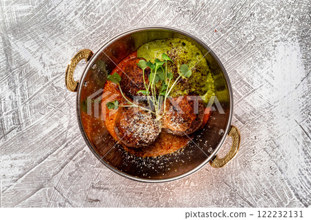 Closeup top view pan of meatballs served with sauce at concrete textured table background. Closeup top view pan of meatballs served with sauce at concrete textured table background. 122232131