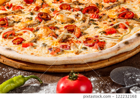 Italian pizza with pepper, cheese at rustic wooden desk background. Closeup image Italian pizza with pepper, cheese at rustic wooden desk background. Closeup image 122232168