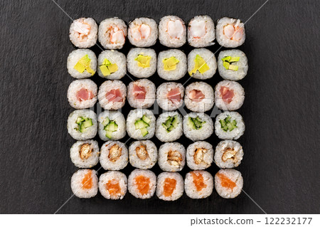 Top view set of sushi rolls at lava texture background. Top view set of sushi rolls at lava texture background. 122232177