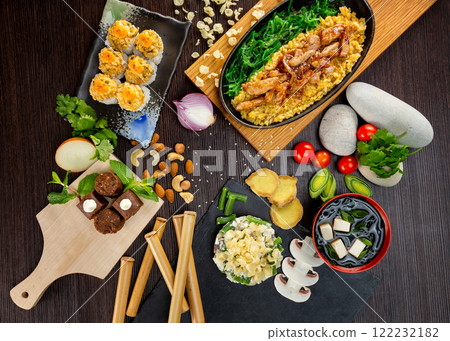 Top view flatlay japanese style business lunch including soup, salad, dessert and main meal at wooden table decorated background. Top view flatlay japanese style business lunch including soup, salad, dessert and main meal at wooden table decorated background. 122232182