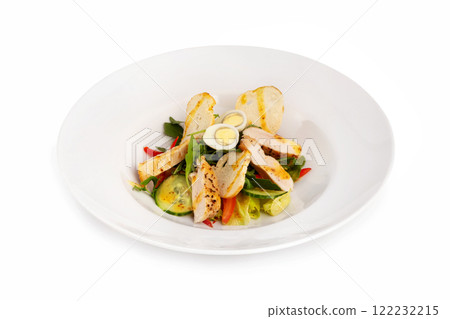 Plate of healthy caesar salad with grilled chicken breast, eggs, croutons, tomato and vegetables isolated at white background. Plate of healthy caesar salad with grilled chicken breast, eggs, croutons, tomato and vegetables isolated at white background. 122232215