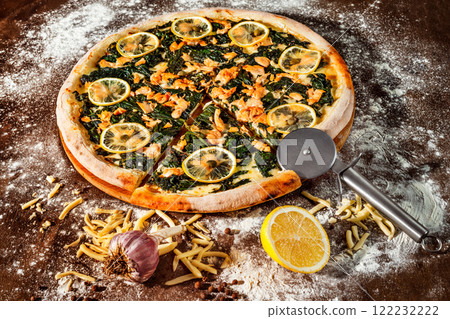 Italian pizza with lemon, cheese and red fish at rustic wooden desk background. Closeup image Italian pizza with lemon, cheese and red fish at rustic wooden desk background. Closeup image 122232222