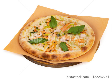 Tasty italian pizza with salmon, seafood and basil on a paper at wooden board isolated at white background. Tasty italian pizza with salmon, seafood and basil on a paper at wooden board isolated at white background. 122232231