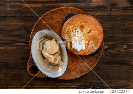 Traditional american apple pie served on a wooden tray and decorated with icecream at wooden table background. Traditional american apple pie served on a wooden tray and decorated with icecream at wooden table background. 122232274