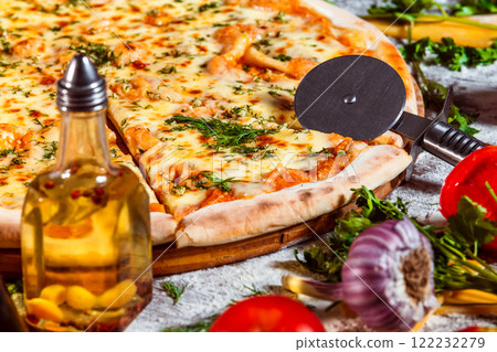 Tasty italian vegeterian pizza with fresh golden cheese and tomato at wooden background. 122232279