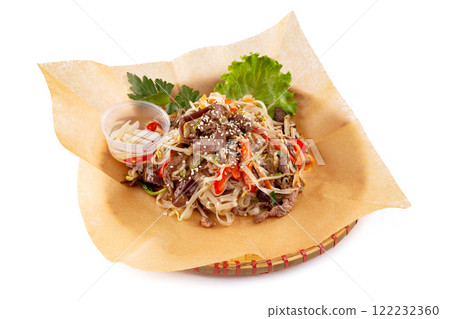 Wicker plate of traditional vietnamese dish - rice noodles with beef meat and vegetables isolated at white background. 122232360
