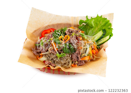 Wicker plate of traditional vietnamese dish - glass noodles with beef meat and vegetables isolated at white background. 122232363