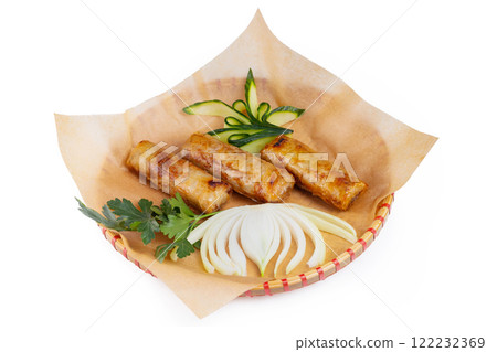Plate of traditional vietnamese food  - cha gio spring rolls served on a wicker plate with paper isolated at white background. 122232369