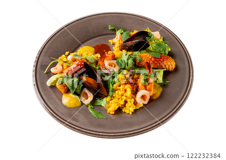 Plate of seafood salad with couscous and spicy sauce isolated at white background. Plate of seafood salad with couscous and spicy sauce isolated at white background. 122232384