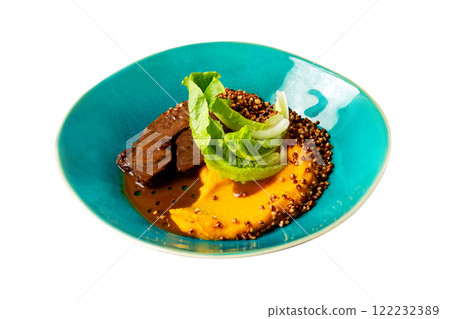 Plate of stewed beef ckeeks served with pumpkin cream isolated at white background. 122232389