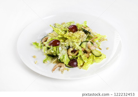 Plate of shrimps salad with soy-bean sauce and green vegetables isolated at white background. Plate of shrimps salad with soy-bean sauce and green vegetables isolated at white background. 122232453