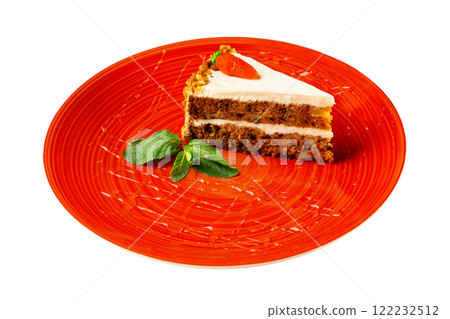 Closeup piece of honey layered cake with cream cheese decorated with mint on a red plate isolated at white background. 122232512