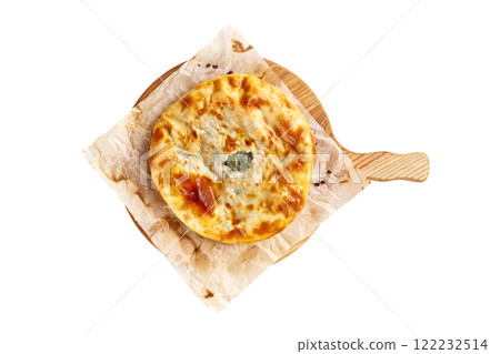Yellow crispy adzharian khachapuri on a cooking paper on a wooden tray isolated at white background. 122232514