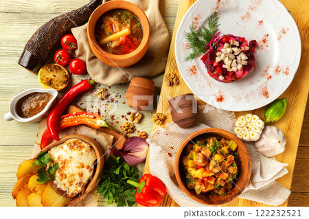 Top view image of traditional georgian lunch with various meals and ingredients at decorated table background. 122232521