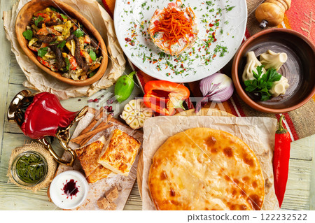 Top view image of traditional georgian lunch with various meals and ingredients at decorated table background. 122232522