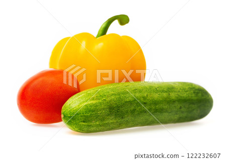 Closeup image of vegetables festive three colors group. Red tomato, green cucumber and yellow pepper isolated at white background. Closeup image of vegetables festive three colors group. Red tomato, green cucumber and yellow pepper isolated at white background. 122232607