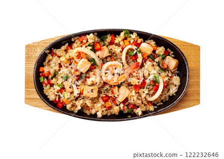 Top view pan of traditional Japanese rice with vegetables and seafood at wooden board isolated at white background. Top view pan of traditional Japanese rice with vegetables and seafood at wooden board isolated at white background. 122232646
