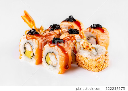 Japanese sushi rolls with salmon, cream cheese, shrimps, masago and teriyaki isolated at white background. Japanese sushi rolls with salmon, cream cheese, shrimps, masago and teriyaki isolated at white background. 122232675