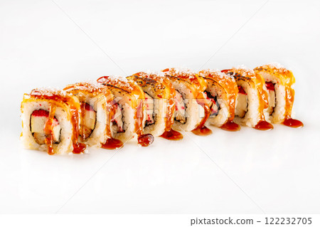 Japanese sushi rolls with cream cheese, masago caviar, eel and salmon decorated with salt and teriyaki sauce isolated at white background. Japanese sushi rolls with cream cheese, masago caviar, eel and salmon decorated with salt and teriyaki sauce isolated at white background. 122232705