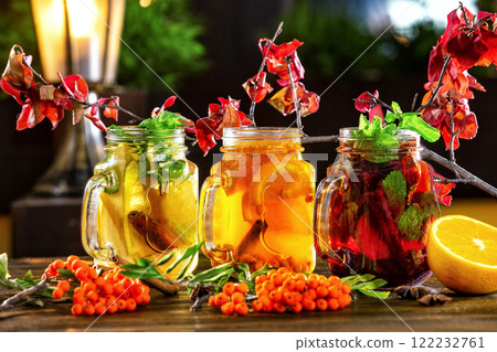 Ice tea jars with fruits decorated with rowan branches at wooden table background. Ice tea jars with fruits decorated with rowan branches at wooden table background. 122232761