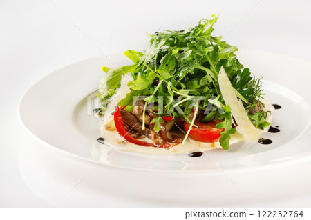 Plate of beef salad served with parmesan, green and tomato isolated at white background. Plate of beef salad served with parmesan, green and tomato isolated at white background. 122232764