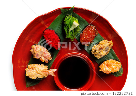 Top view plate of sushi set served with sauce isolated at white background. Top view plate of sushi set served with sauce isolated at white background. 122232781