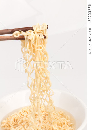 Instant noodles on a plate and chopsticks spoon isolated on white background Instant noodles on a plate and chopsticks spoon isolated on white background 122233276