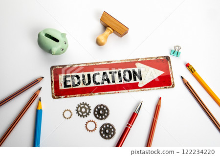 EDUCATION Concept. Red direction arrow with text on white office desk EDUCATION Concept. Red direction arrow with text on white office desk 122234220