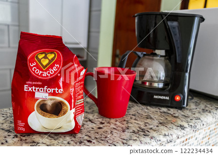 Coffee machine and red cup on table in the kitchen. Coffee machine and red cup on table in the kitchen. 122234434