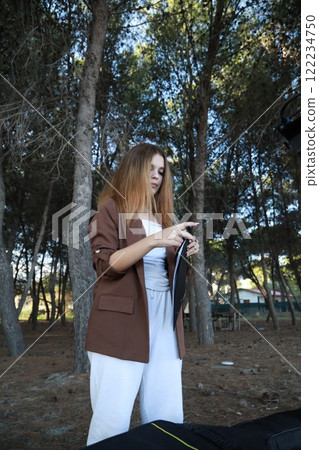 Girl Walks With Guitar Bass Instrument Case Behind Her In The Park Girl Walks With Guitar Bass Instrument Case Behind Her In The Park 122234750