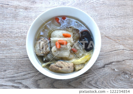 boiled bamboo mushroom with pork bone and black ear mushroom in clear Chinese herb soup on bowl 122234854