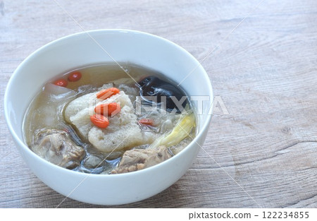 boiled bamboo mushroom with pork bone and black ear mushroom in clear Chinese herb soup on bowl boiled bamboo mushroom with pork bone and black ear mushroom in clear Chinese herb soup on bowl 122234855