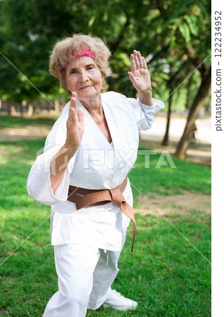 Mature lady in kimono exercising outdoors 122234952
